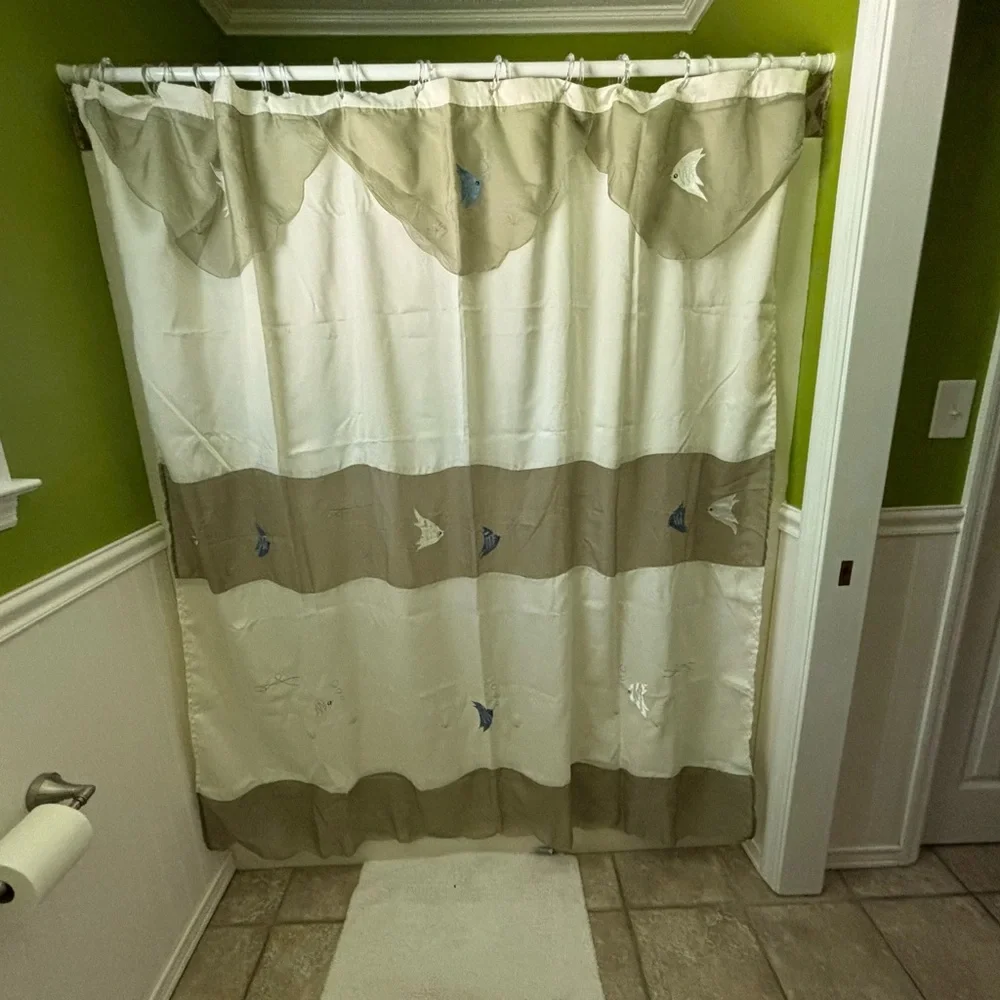 Green and cream fabric shower curtain with embroidered fish